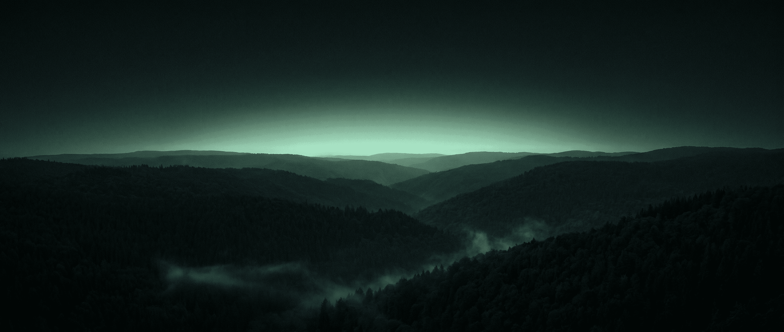 Wide valley under low cloud